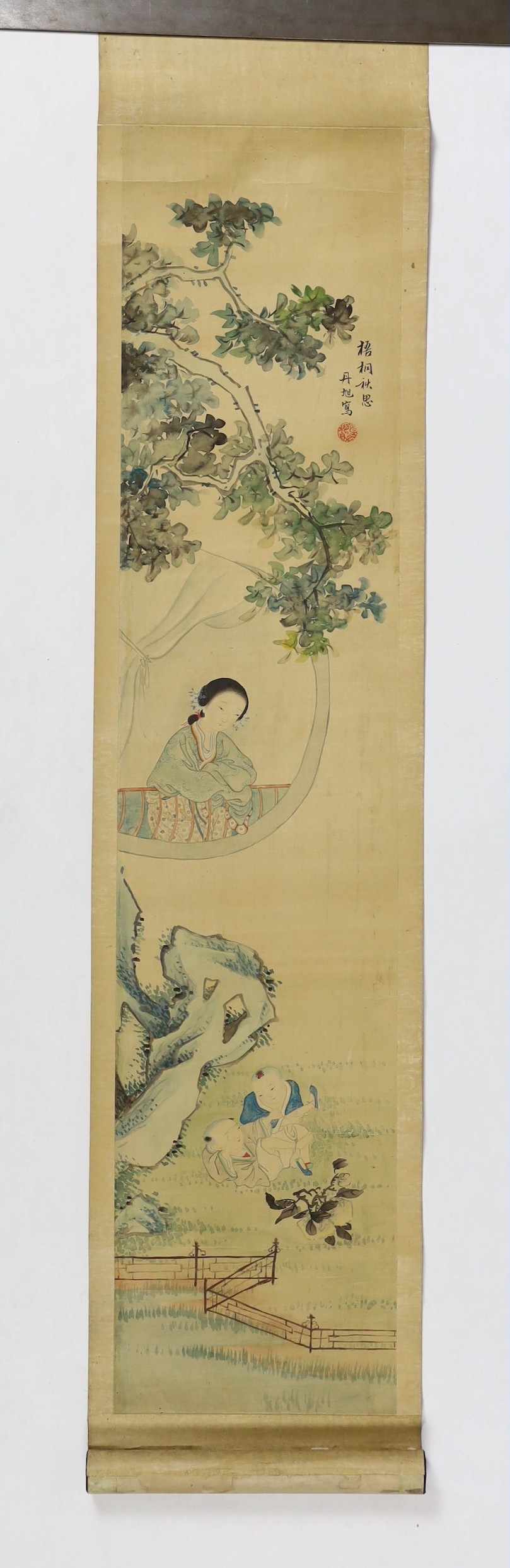 A Chinese scroll painting on silk of a mother watching her children play in a garden, 19th century, image 95cm x 21cm